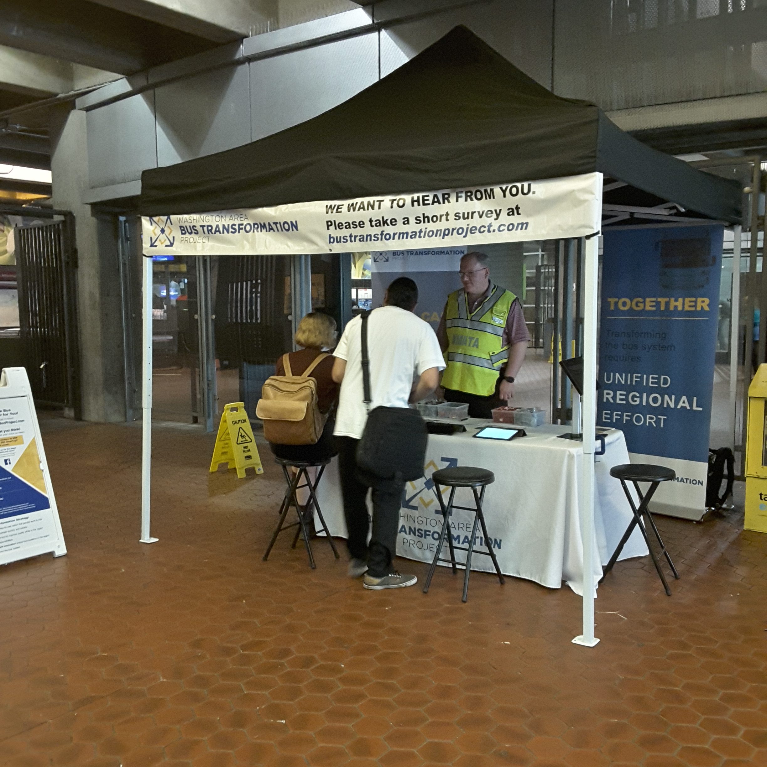 Event booth with people at the Rosslyn Metro Station