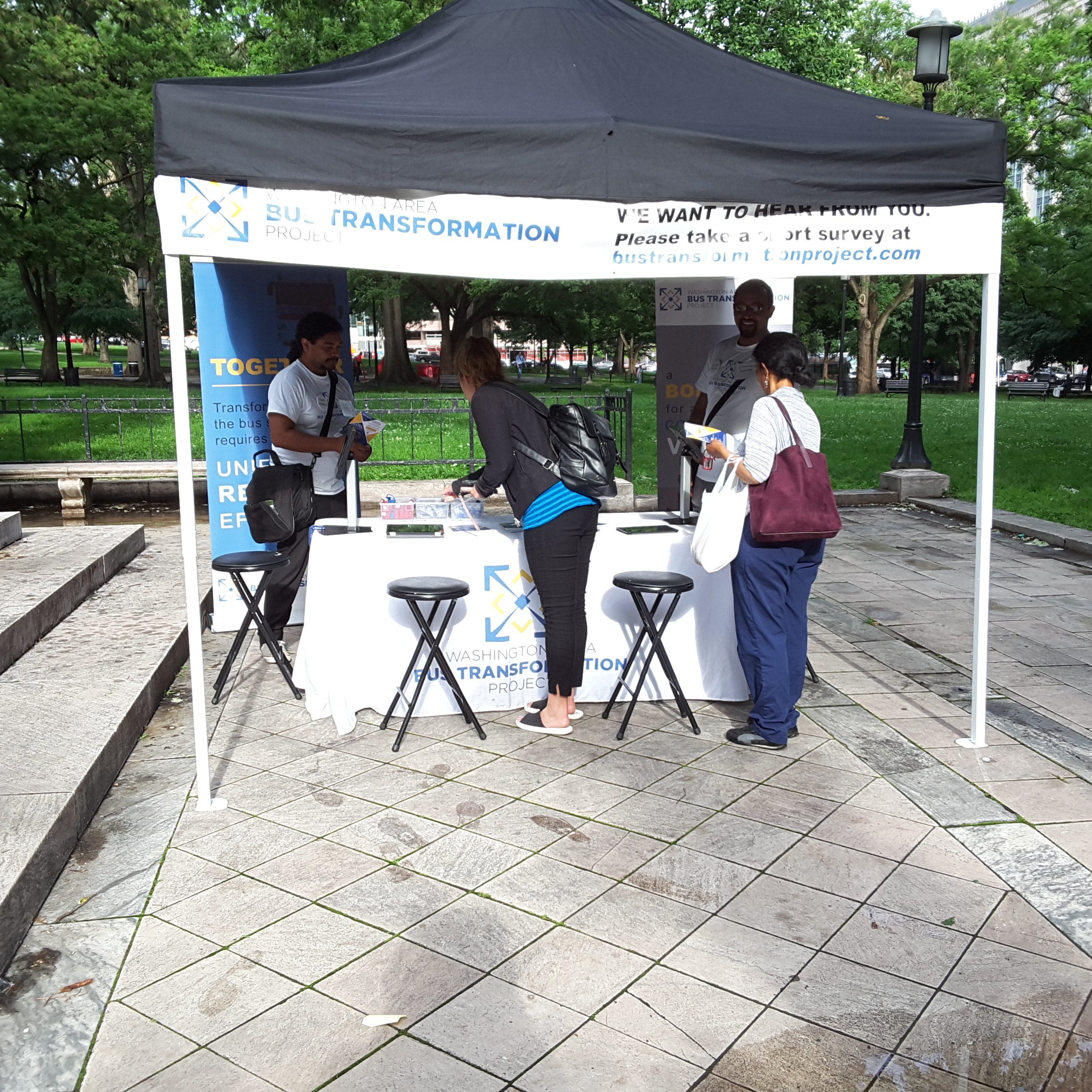 Event booth with people at the McPherson/Franklin Square Park