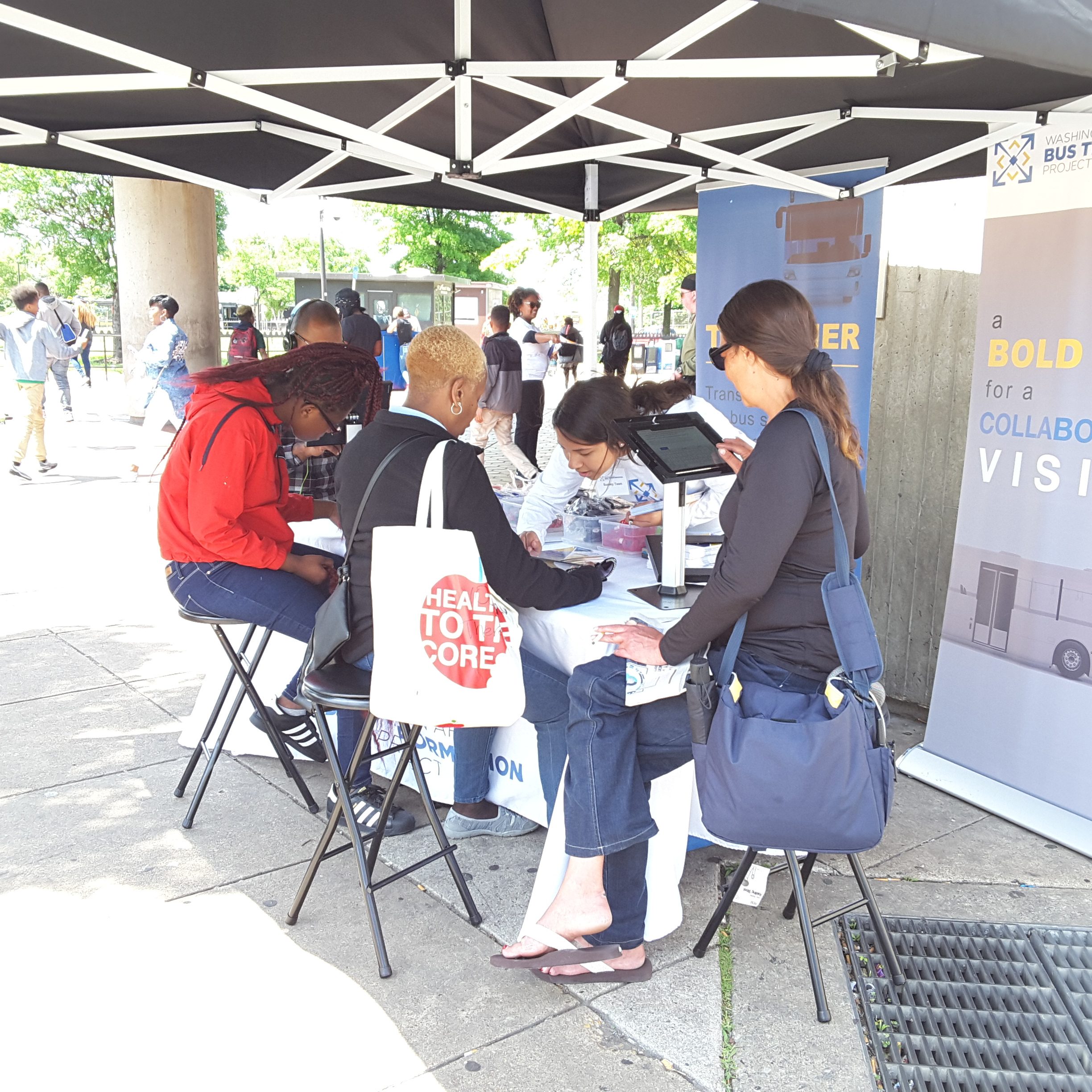 People gathered at the Anacostia Metro Station popup event booth